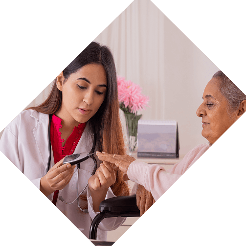 Doctor checking blood sugar level of elderly woman during home visit