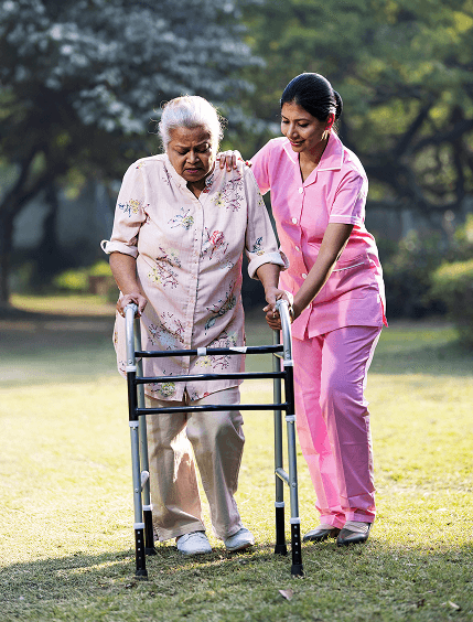 Caregiver helping woman with walker