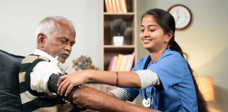 Nurse checking elderly man’s BP