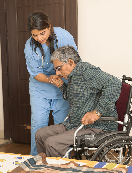 Nurse helping man from wheelchair