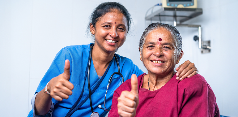 Nurse and woman smiling with thumbs up